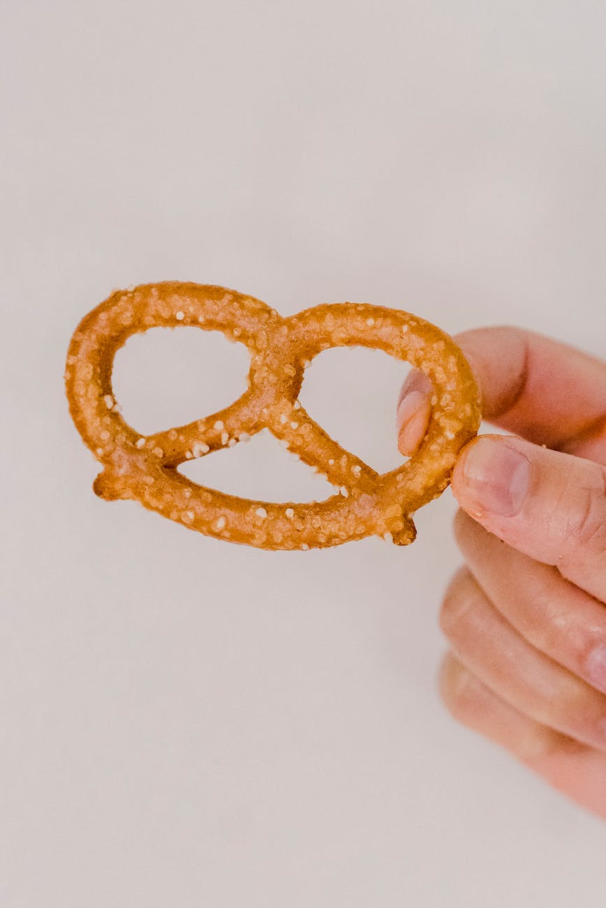 crunchy pretzel with grains of salt in hand