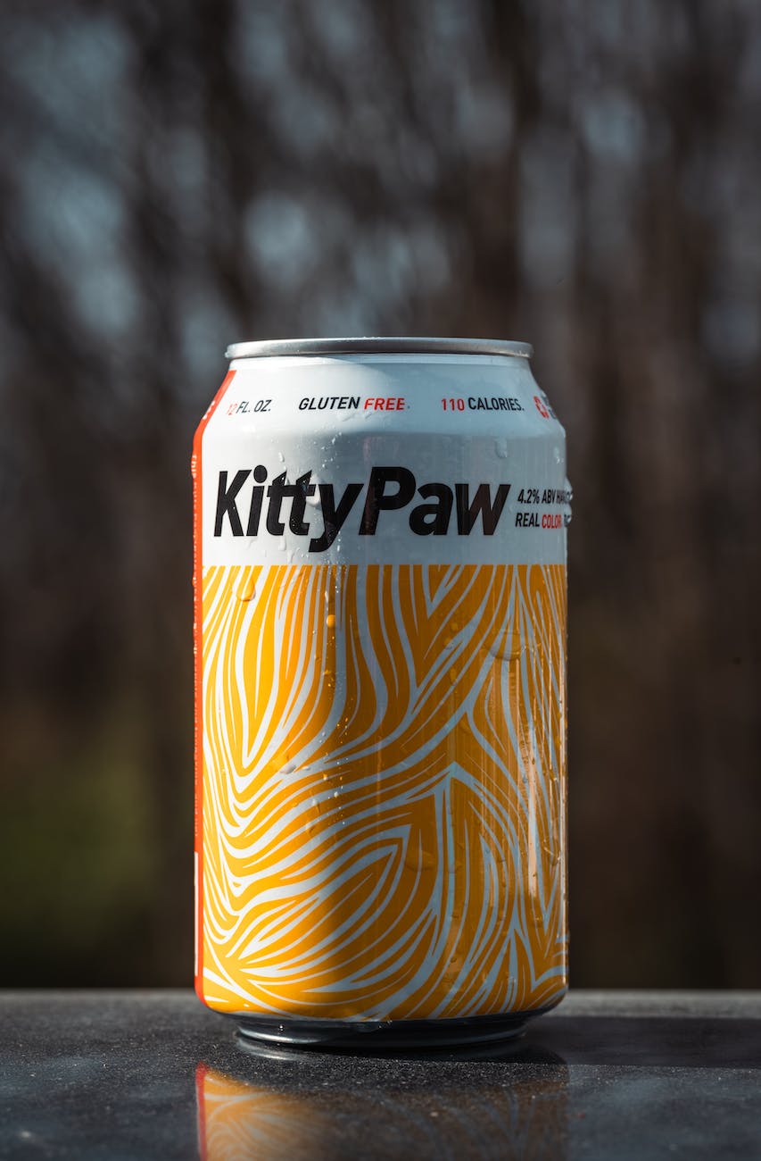 close up photo of a kitty paw cold drink