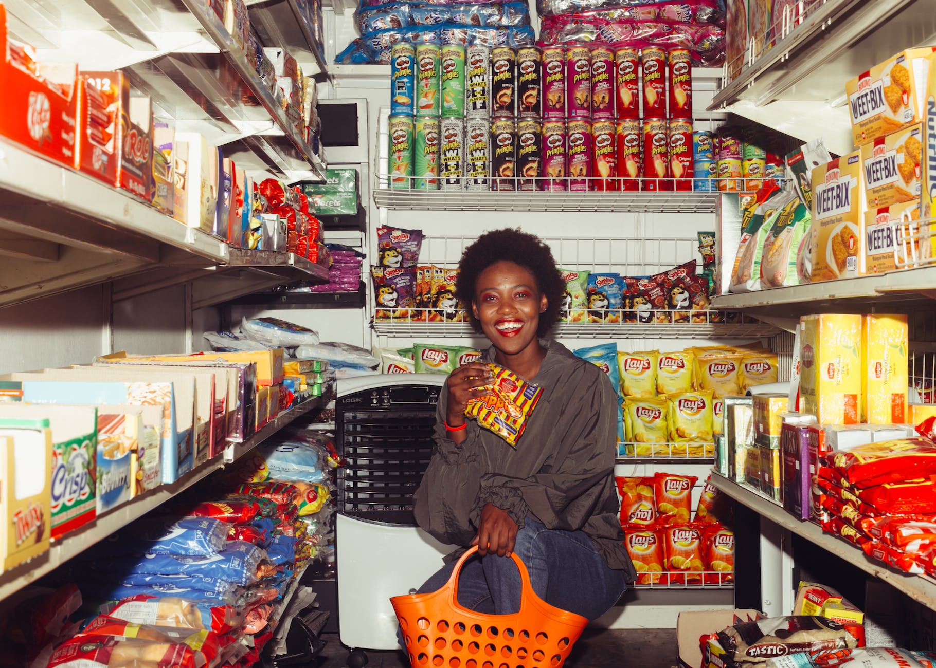 happy woman buying groceries in a convenience store